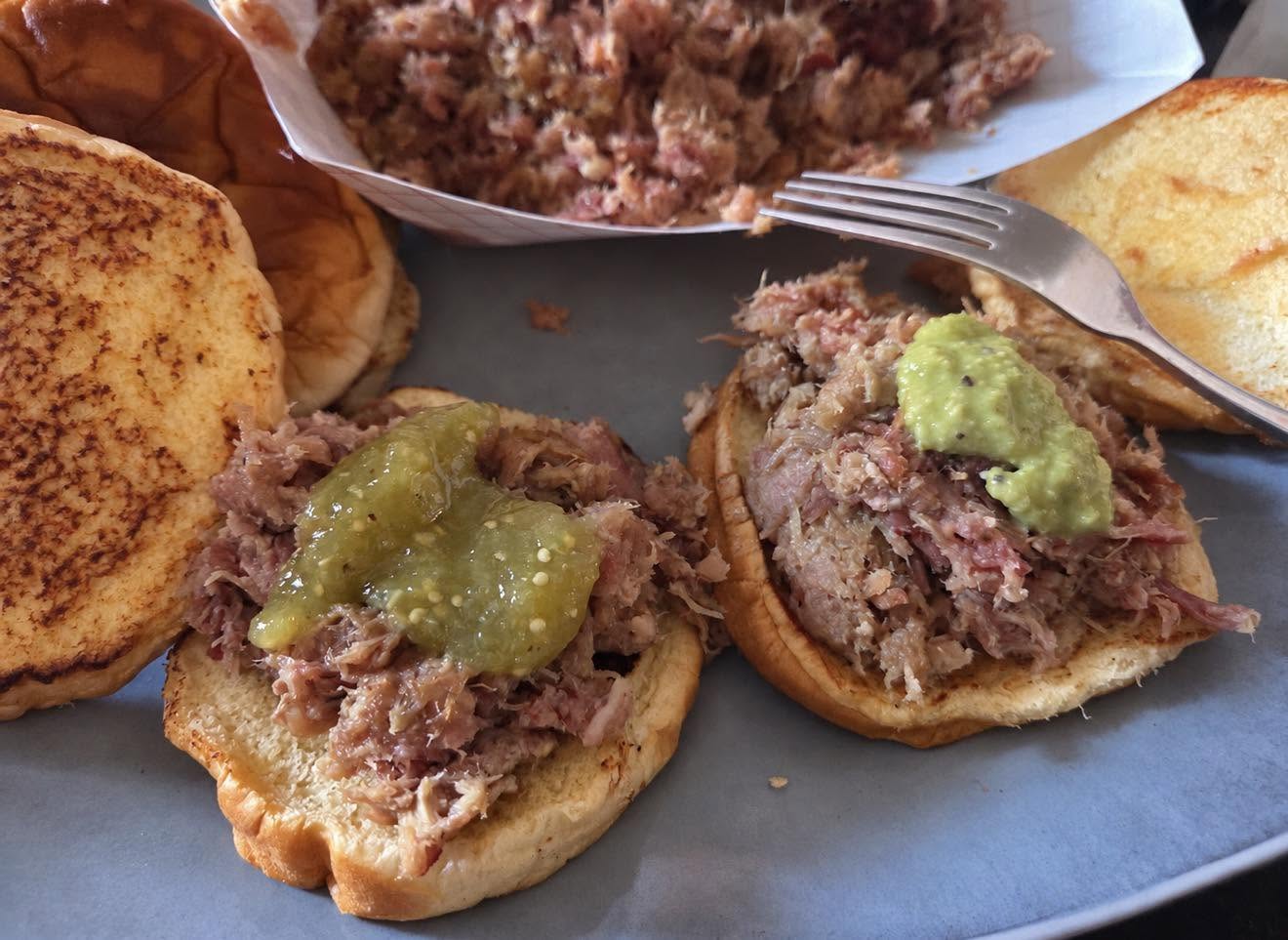 Kalua pork on toasted buns with green salsa